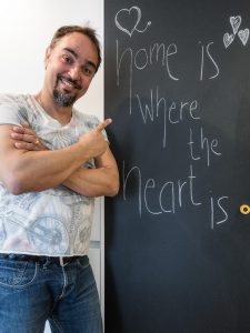 Tom vor Tafel mit Schriftzug "home is where the heart is"