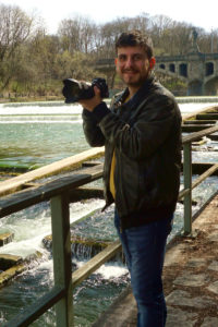 Martin Ratkovic steht mit seiner Kamera in der Hand am Isarufer. Foto: Nina Jarosch